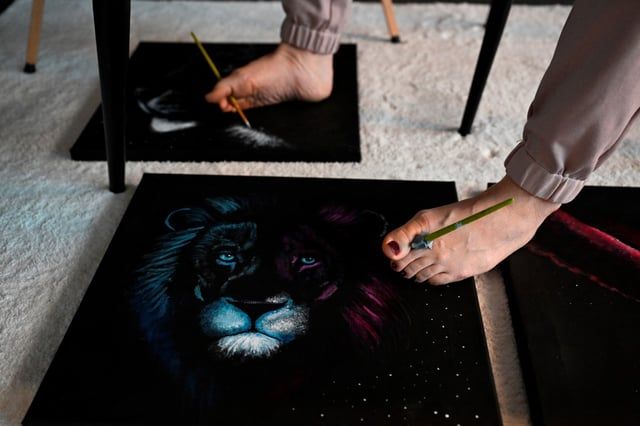 بطريقة مذهلة.. فنانة ترسم عشر لوحات في وقت واحد (صور)